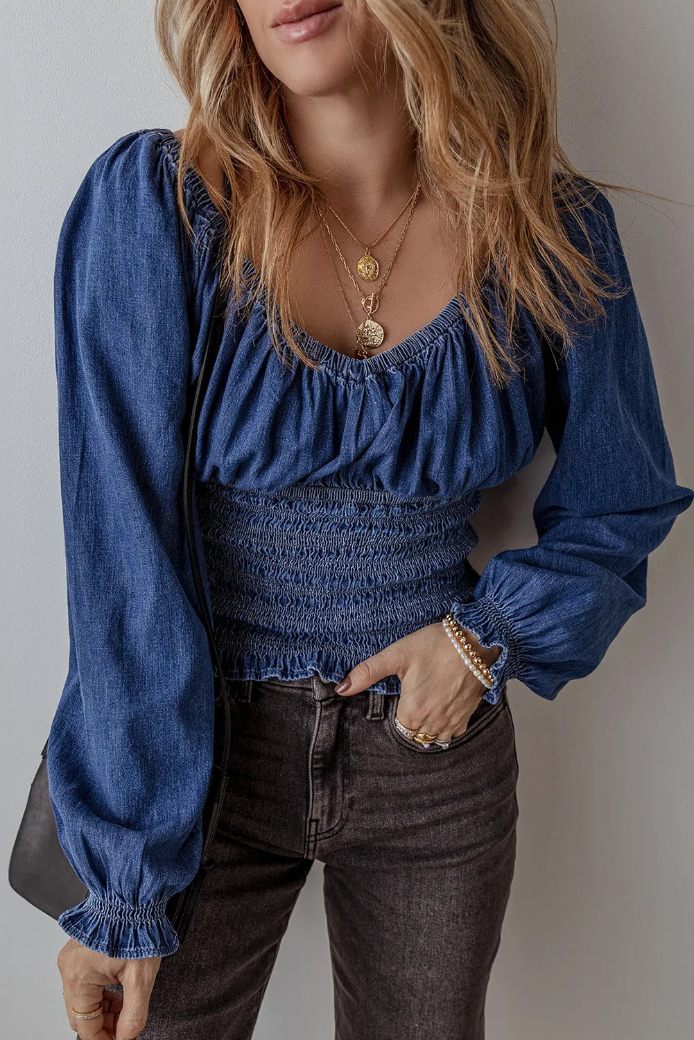 Medium wash denim corset bodice blouson top with smocked waist and blouson sleeves