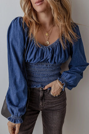 Medium wash denim corset bodice blouson top with smocked waist and blouson sleeves