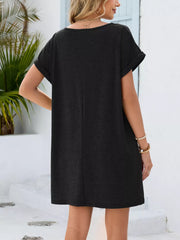 Black V-neck pocket dress with cuffed short sleeves and a relaxed fit.