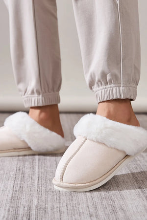 Beige suede house slides with cozy white shearling trim.