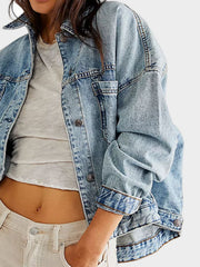 Light wash oversized denim trucker jacket with button front and cuffs.