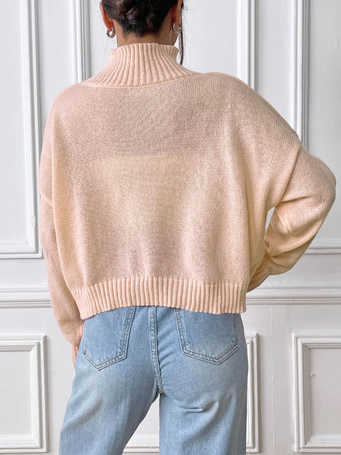 Apricot knit turtleneck sweater with ribbed trim and embroidered heart detail