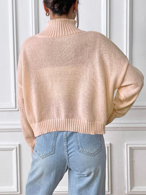 Apricot knit turtleneck sweater with ribbed trim and embroidered heart detail
