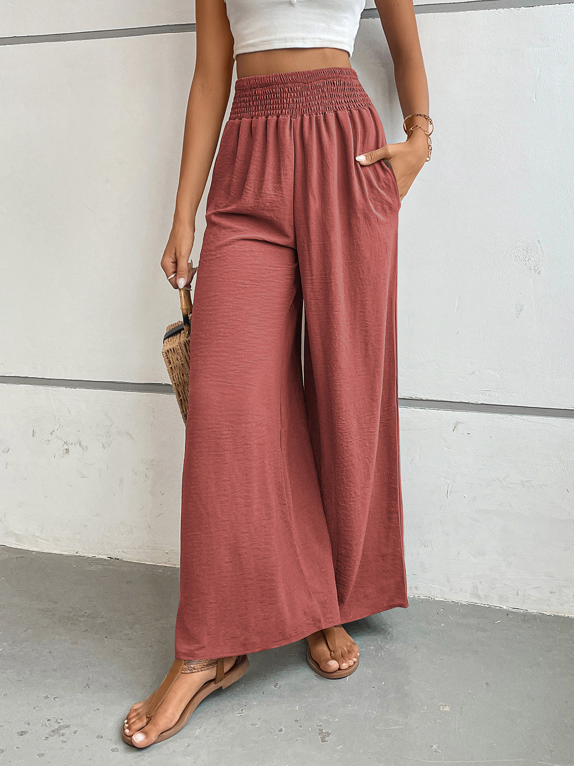 Rust textured palazzo lounge trousers with smocked waist and wide legs.