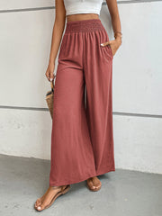 Rust textured palazzo lounge trousers with smocked waist and wide legs.