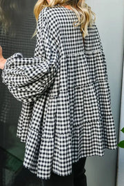 Gingham tiered blouson sleeve top in plaid with blouson sleeves and tiered skirt.