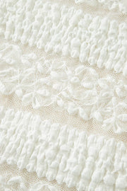 White lace patchwork sheer t-shirt with textured fabric and floral details.