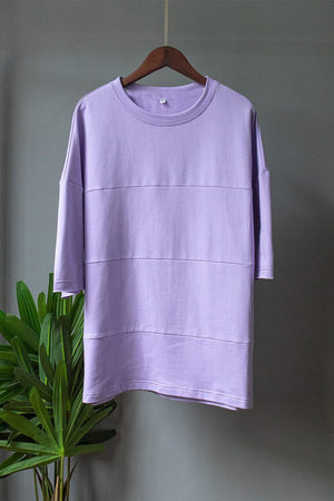 Lavender sweatshirt with horizontal seam details and relaxed fit.