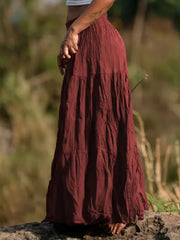 Burgundy tiered maxi skirt with elastic waist and crinkled texture.