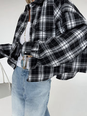 Oversized black and white plaid cotton button-up shirt with collar and chest pockets.