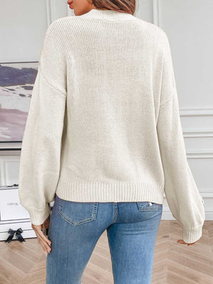 White acrylic knit cardigan with embroidered blossoms on sleeves, relaxed fit, ribbed cuffs and hem.