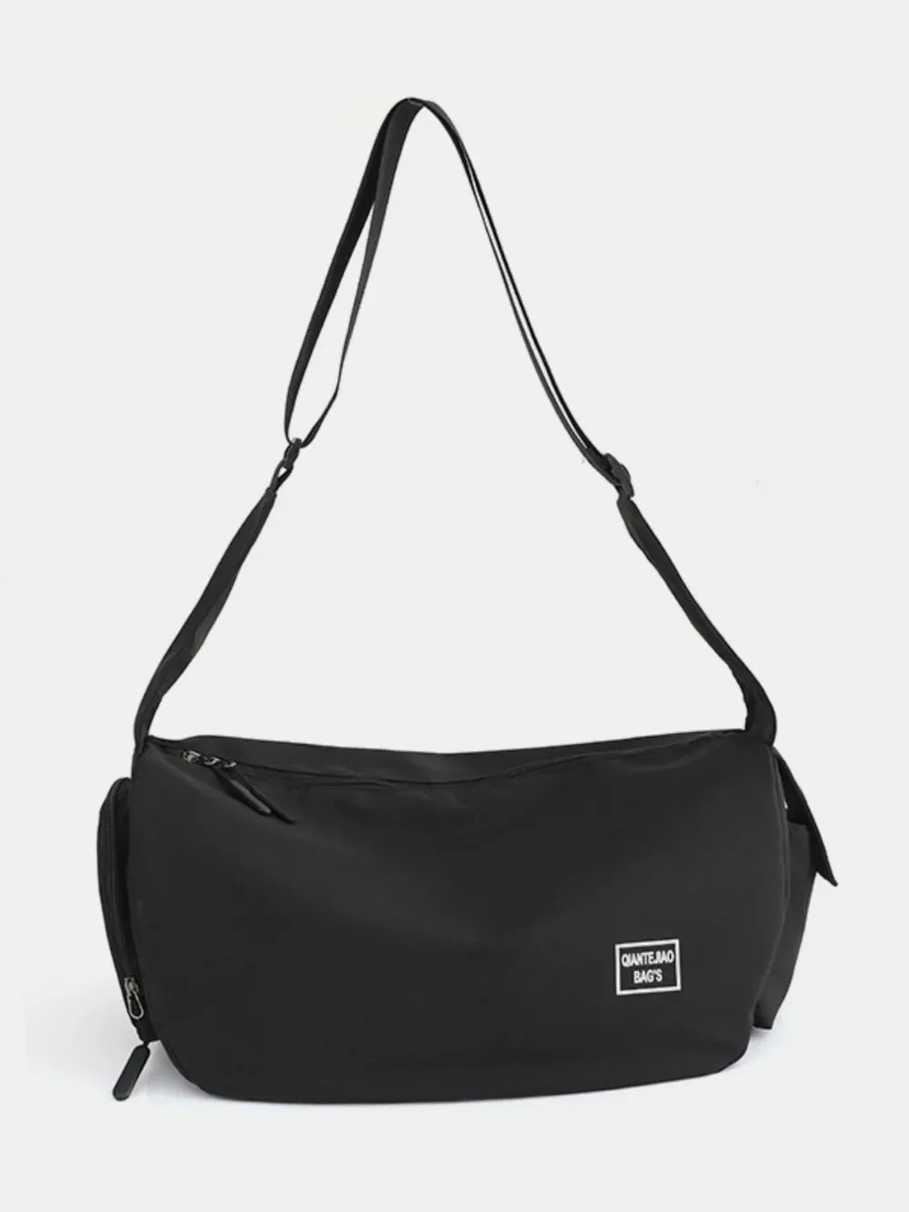 Black slouchy crescent crossbody bag with adjustable strap and white logo patch.