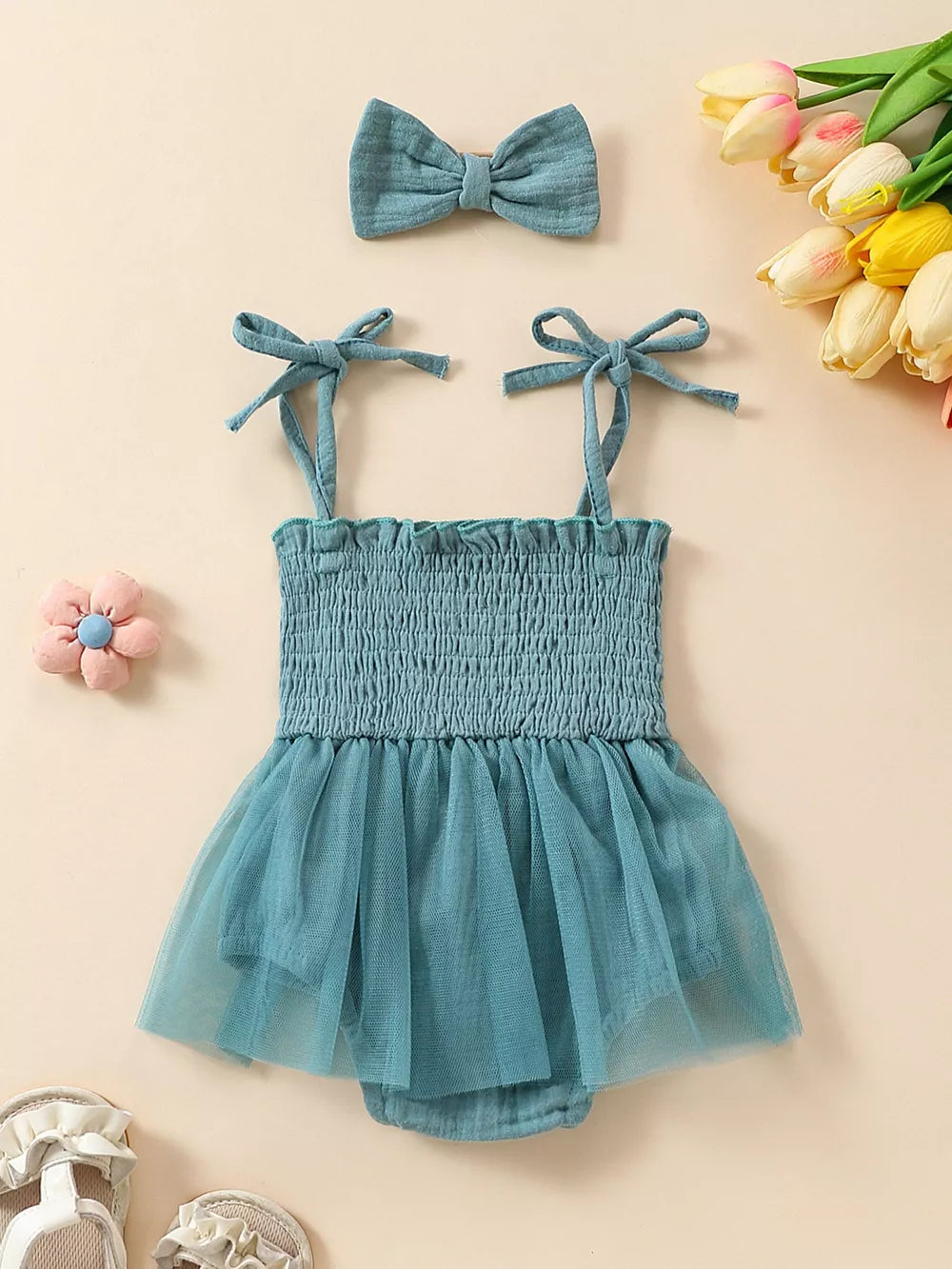 Sea blue smocked bodysuit with tulle skirt and matching bow headband.