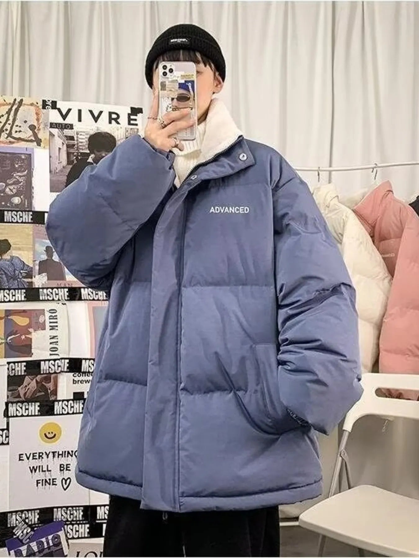 Blue oversized quilted puffer jacket with white trim and "ADVANCED" text detail.