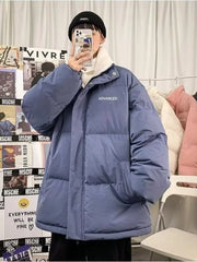 Blue oversized quilted puffer jacket with white trim and "ADVANCED" text detail.