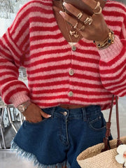 Charming cropped red and pink striped knit cardigan with button front and balloon sleeves.
