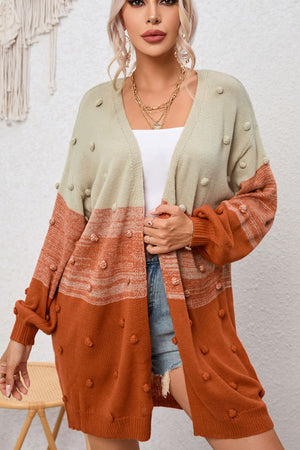 Textured colorblock bobble cardigan in pink and caramel acrylic with a V-neck and long sleeves.