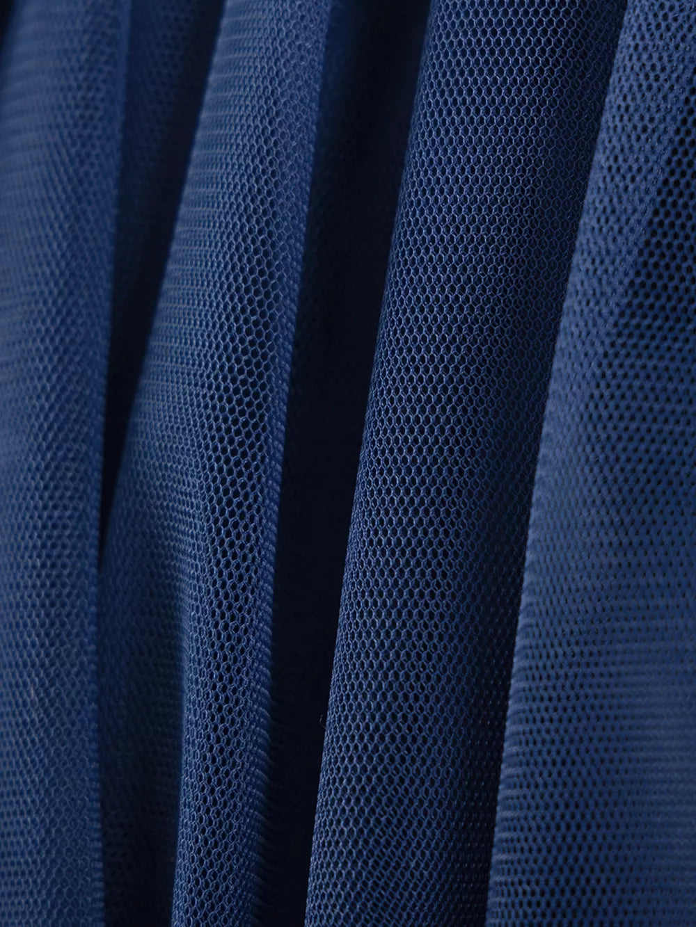 Navy blue tulle fabric with a fine mesh texture, showing soft pleats and folds.