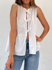 White peplum blouse with bow-tie back detail and split front.