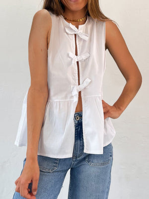 White peplum blouse with bow-tie back detail and split front.