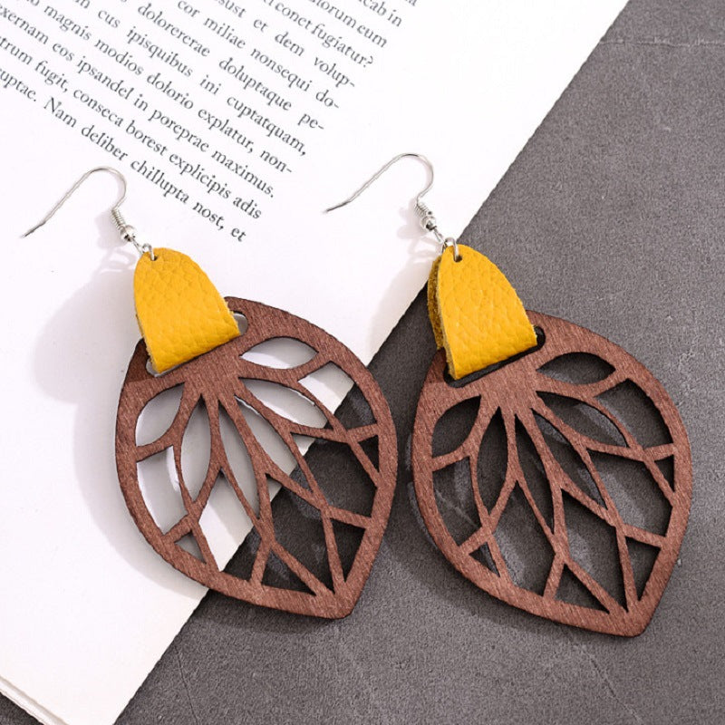 Leaf cutout wood dangle earrings with yellow leather accent