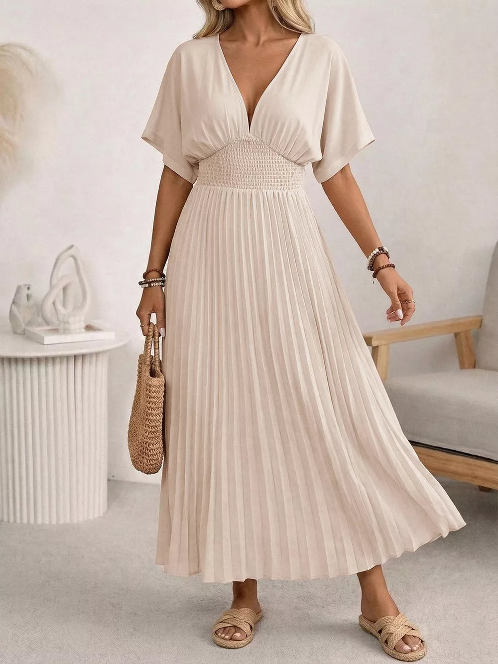 Elegant apricot pleated midi dress with v-neck and smocked waist, short sleeves.