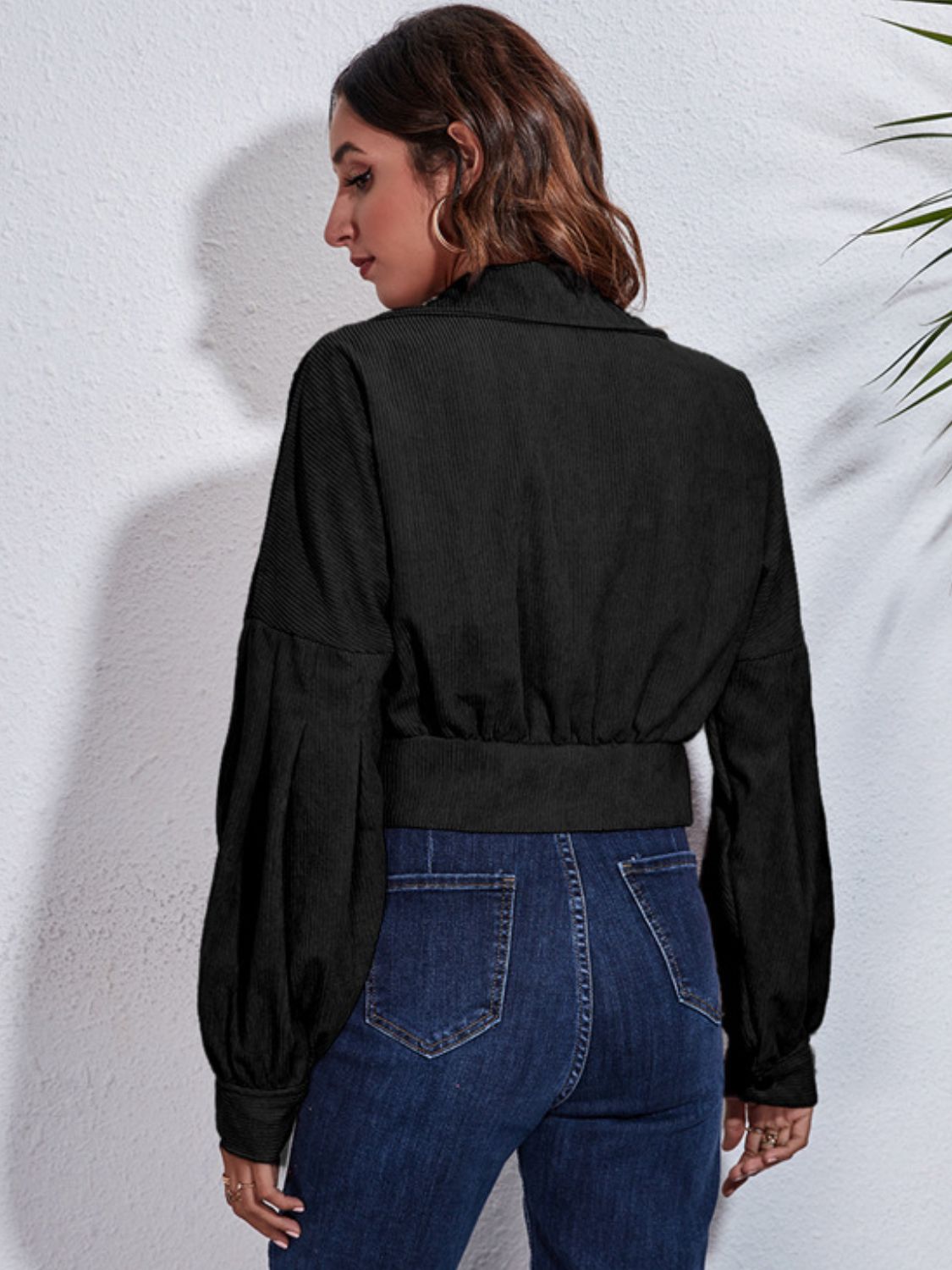 Black corduroy cropped jacket with balloon sleeves and button details.