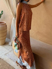 Brown polka dot maxi skirt with white lace trim, paired with a matching sleeveless high-neck top.