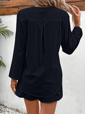 Black linen henley shirt with drawstring shorts set, featuring a back pleat detail.