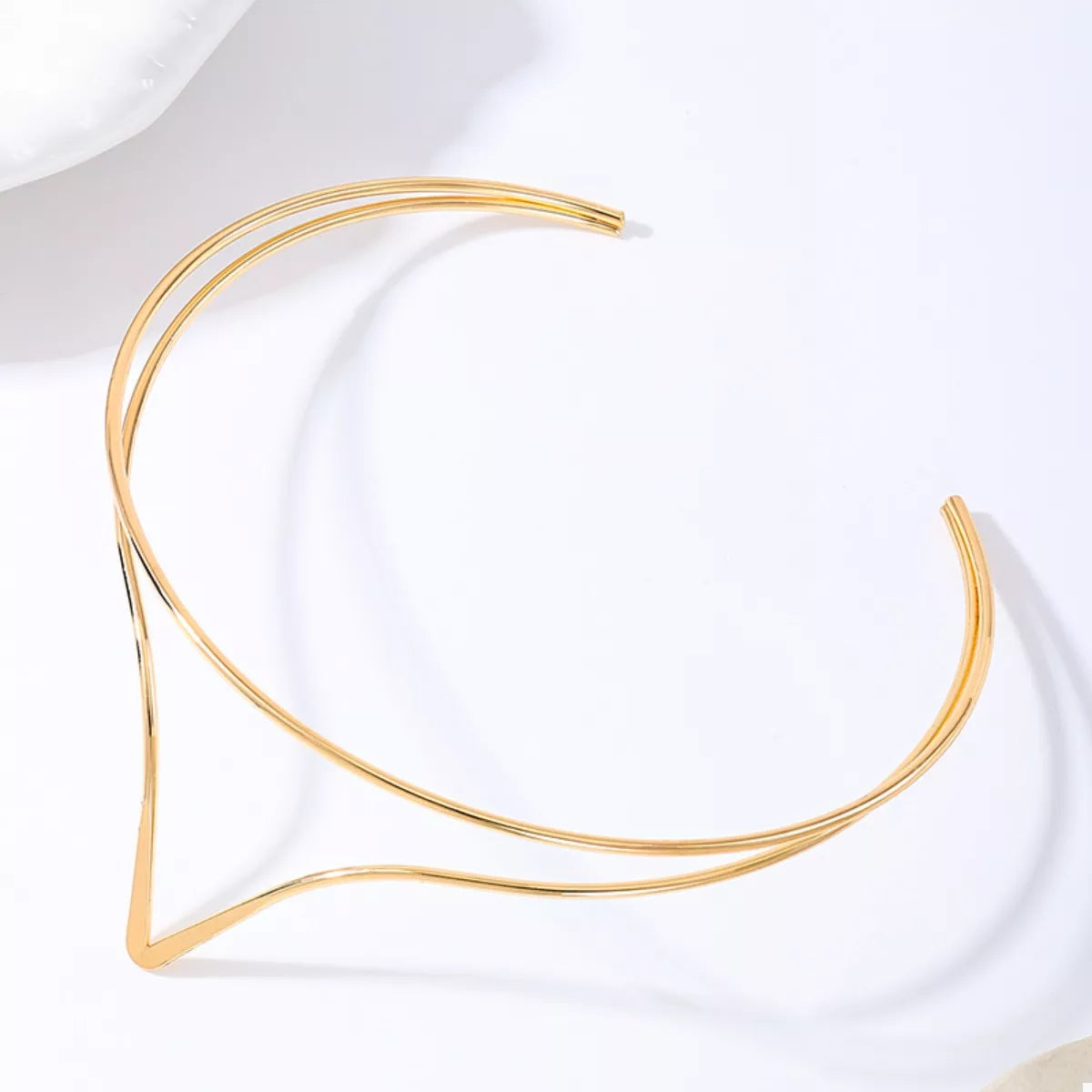 Golden V-shaped double layer choker necklace with open ends.