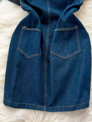Denim overall dress with distressed details and two front pockets.