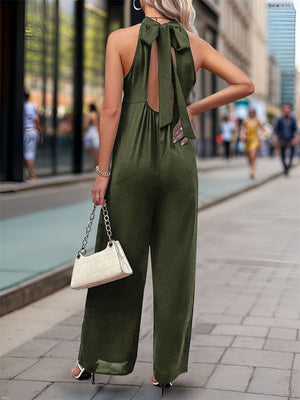 Dark green halter neckline wide leg jumpsuit with back tie detail.