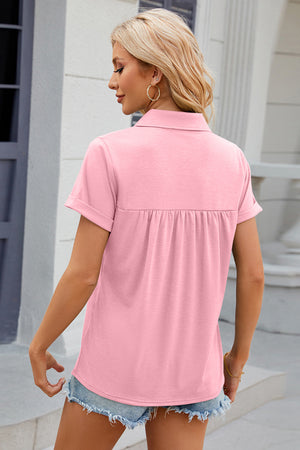 Blush pink polo top with short sleeves and gathered yoke detail.