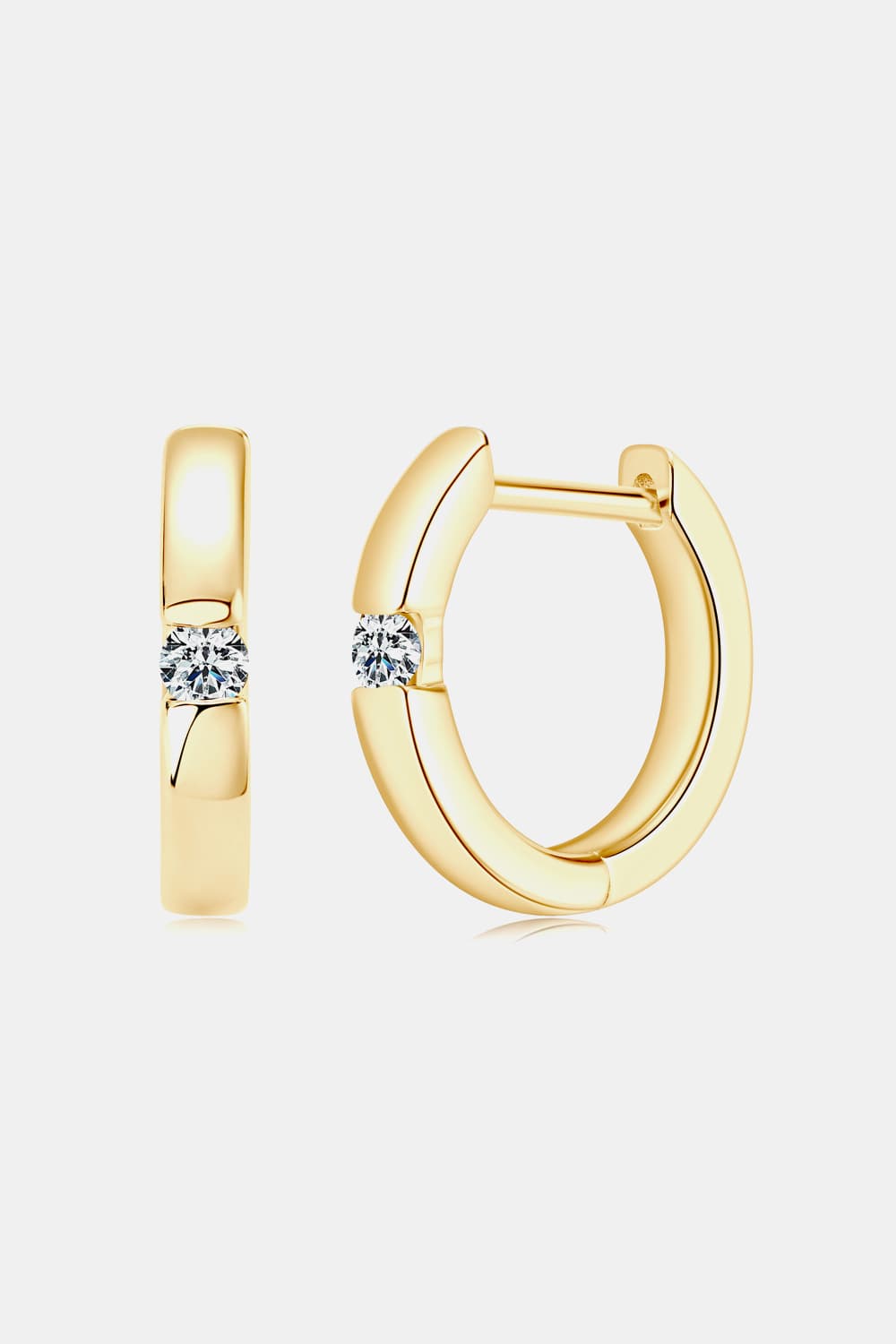 Gold pavé point huggie hoops with a single clear stone detail.