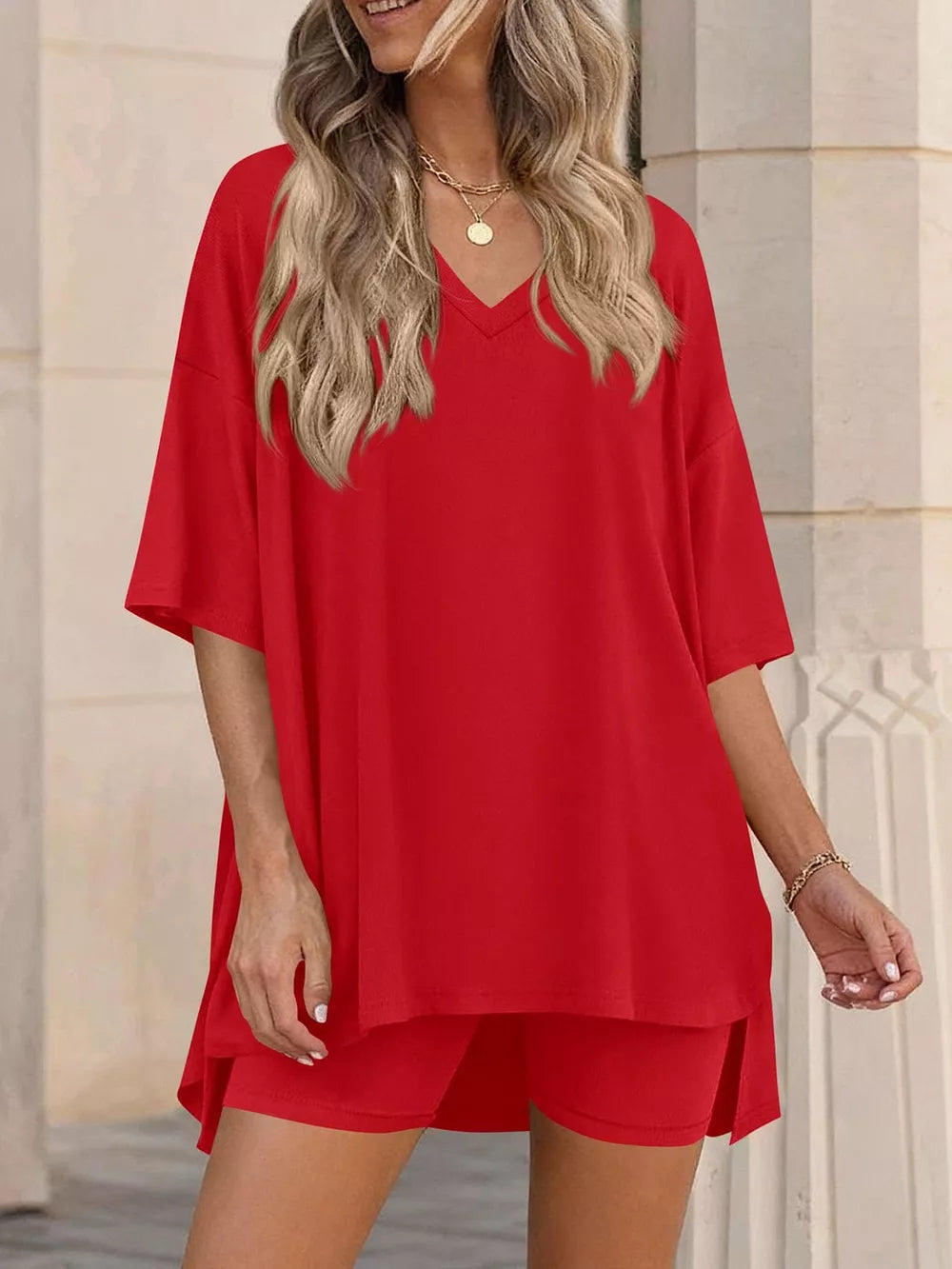 Red V-neck two-piece set with oversized top and shorts, casual women's outfit.