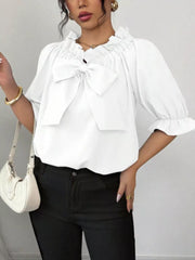 White ruffled bow sleeve blouse with cinched neckline and flared cuffs.