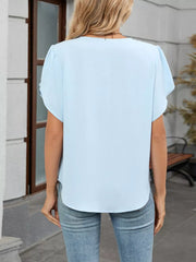 Sky blue polyester pleated short sleeve blouse with a V-neck and curved hem.