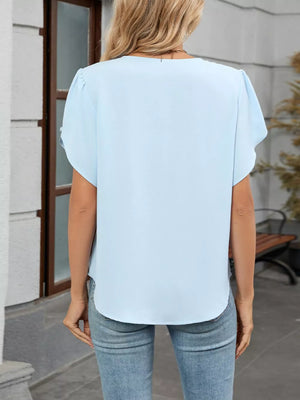 Sky blue polyester pleated short sleeve blouse with a V-neck and curved hem.