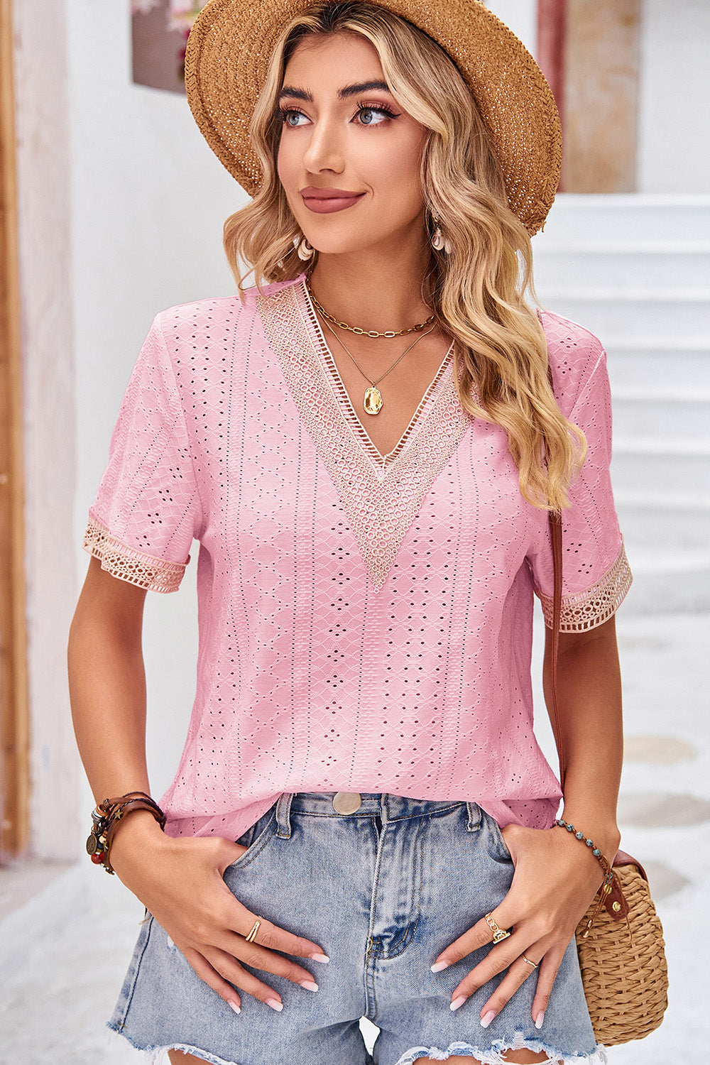 Pink eyelet V-neck blouse with lace trim and short sleeves