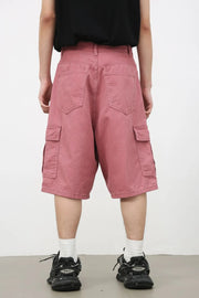 Magenta baggy cargo bermuda shorts with textured fabric and multiple pockets.