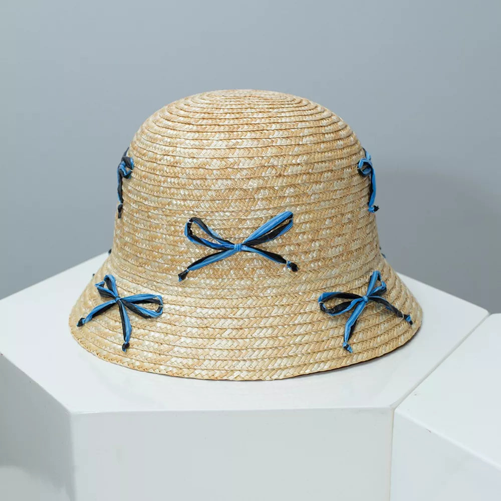 Woven straw bucket hat with blue and black bowknot details
