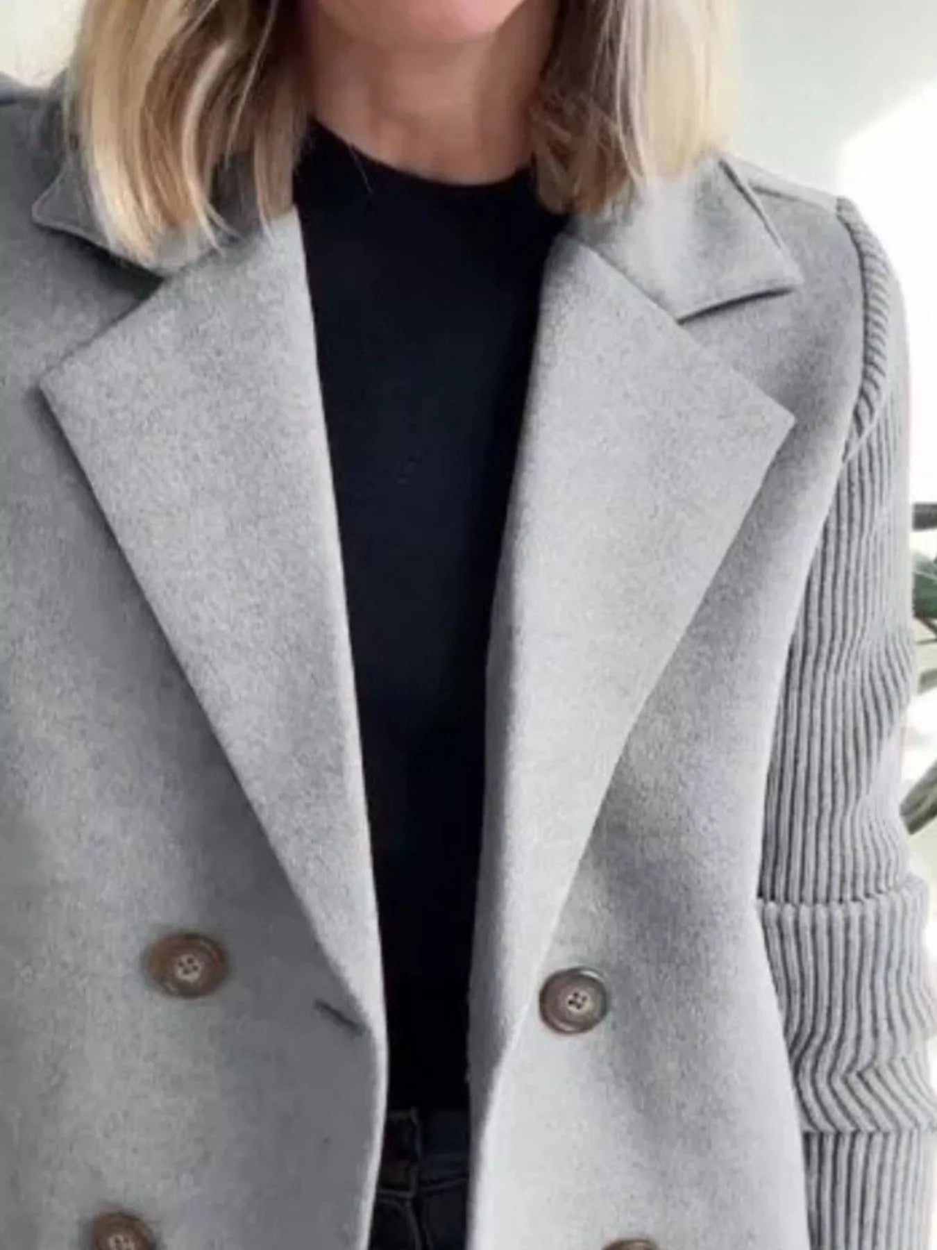 Gray double-breasted wool blend blazer with button detail and ribbed sleeves.