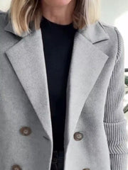 Gray double-breasted wool blend blazer with button detail and ribbed sleeves.