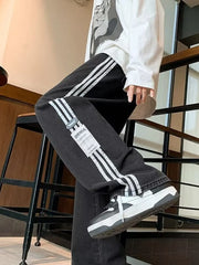 Men's black oversized wide-leg jeans with white side stripes and a casual fit.