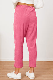 Hot Pink corduroy barrel-leg utility pants with elastic waist and pockets.