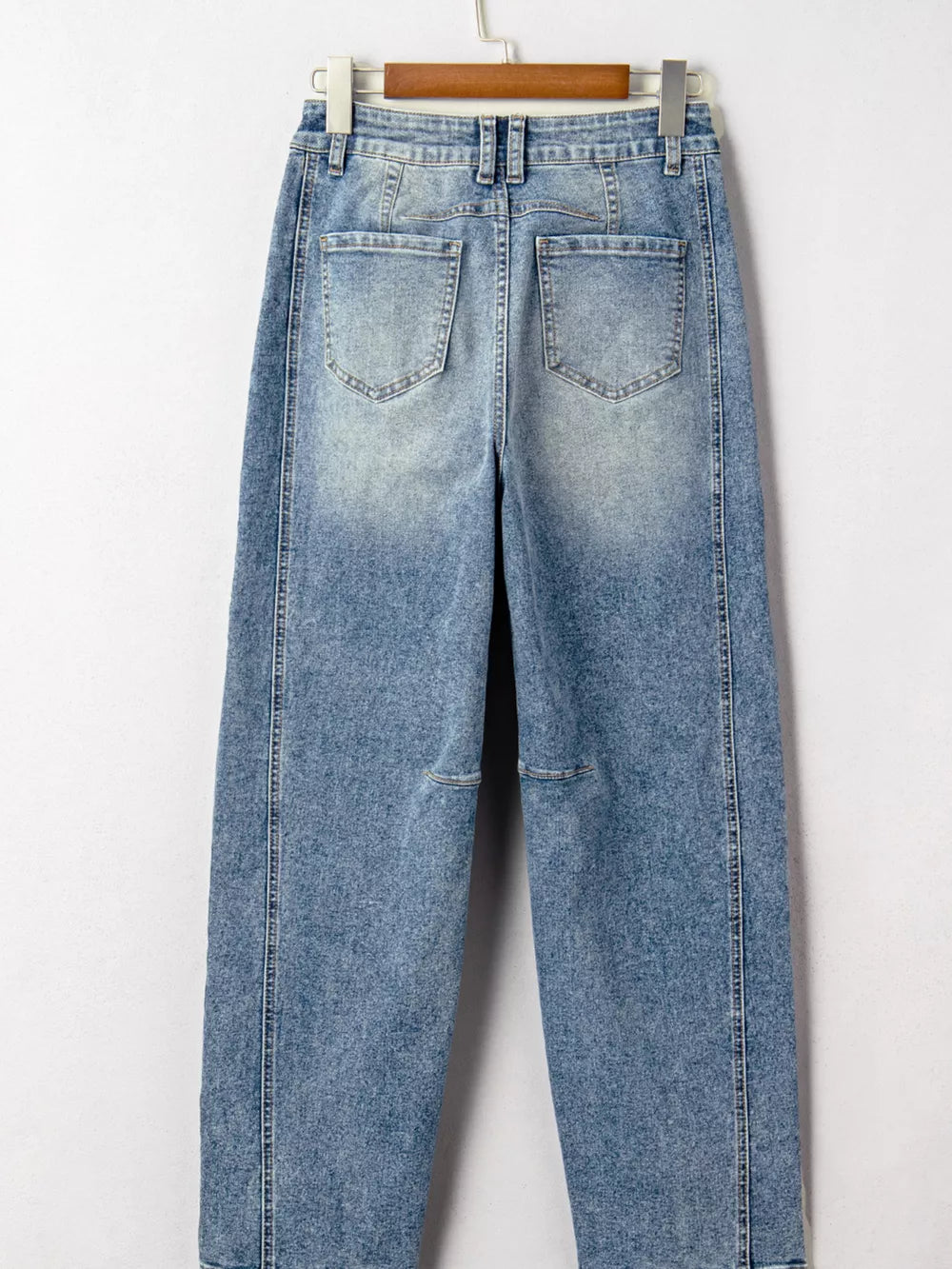 Vintage-inspired high-waisted seam maternity jeans in light wash denim with cuffed hems.