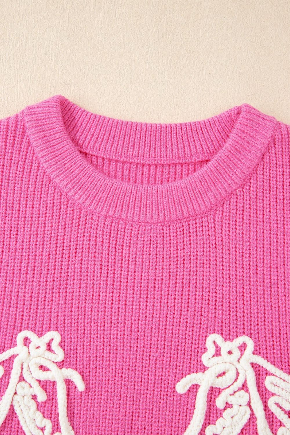 Fuchsia pink ribbed knit vest with embroidered equine detail and crew neck.