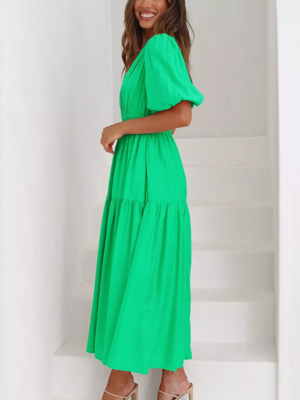 Green midi dress with puff sleeves, V-neck, and tiered skirt.