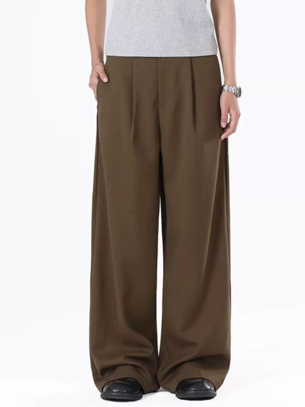 Men's brown flowy wide-leg sweatpants with pleats and pockets.