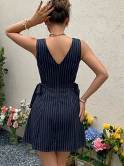 Navy striped tie-waist a-line dress with V-neck and sleeveless design.